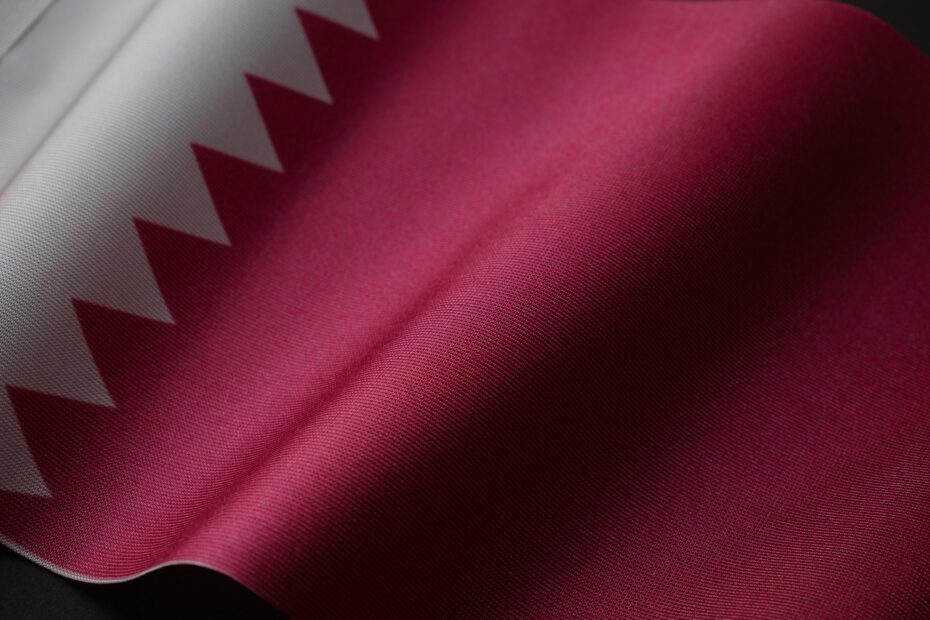 A detailed close-up of the Qatar national flag showcasing its unique design and colors.