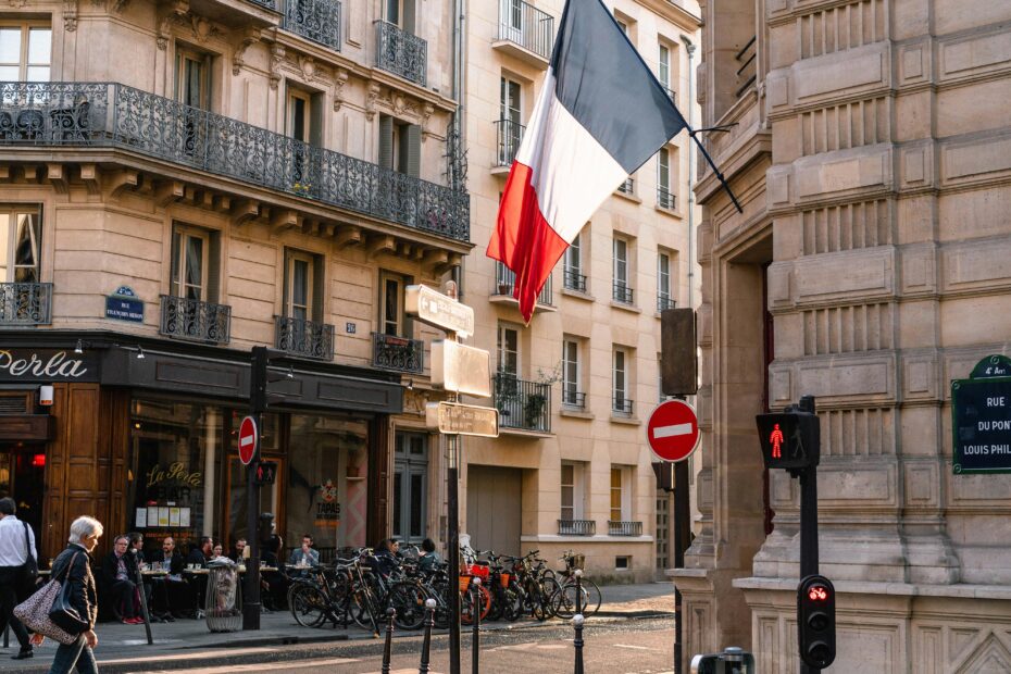 Charming Paris street with French flag and classic architecture.