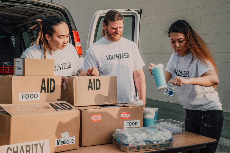 Volunteers sort aid and food boxes for a charity drive, promoting togetherness and social good.