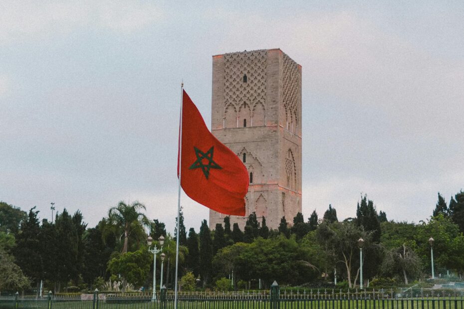 Capture of the iconic Hassan Tower with the Moroccan flag in Rabat, showcasing historic architecture.